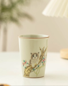 Detail of Ru Kiln ceramic teacup featuring hand-painted cat and floral glaze patterns