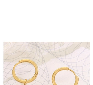 Close-up of minimalist gold-finish metal hoop earrings with polished surface detail