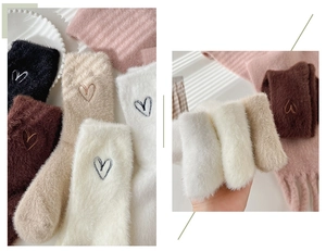 Detail of plush mink fleece socks with heart embroidery in multiple colors and textures