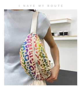 Close-up of cream woven waist bag featuring rainbow leopard print and metal zipper