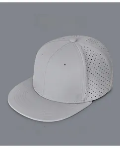 Detail view of grey flat brim hip hop hat showing laser-cut ventilation holes and stitching