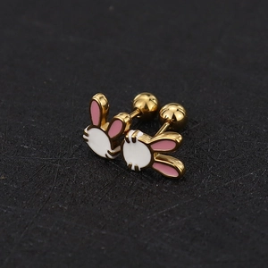 Macro view of cute gold rabbit screw back earrings with pink and white enamel details