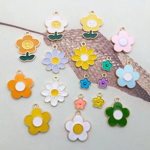 Close-up of colorful enamel flower charms in various styles for DIY jewelry making