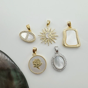 Detailed collection of golden seashell charms including flower and sun patterns for DIY jewelry