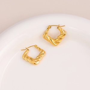 Minimalist 18K gold stainless steel twisted square hoop earrings for women on a tray