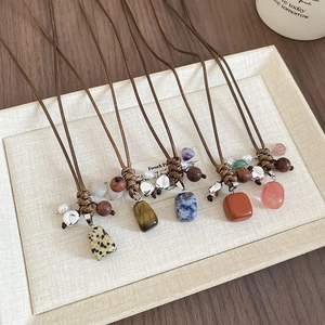 Detailed shot of ethnic wax rope necklaces with assorted natural stones and wood beads