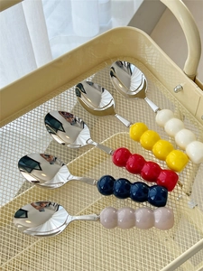 Detailed view of colorful beaded ceramic handles on 304 stainless steel dessert spoons