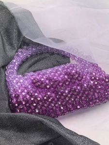 Macro shot of purple gradient beaded handbag crafted with translucent acrylic beads