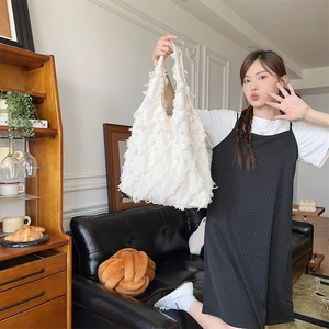 Detail of white fringe canvas tote bag featuring floral textured handmade design