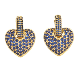 Detail of gold heart earrings featuring pavé-set blue cubic zirconia stones