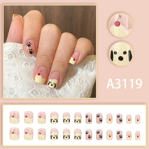 Short square press-on nails with cartoon dog and cherry patterns in soft cream and pink