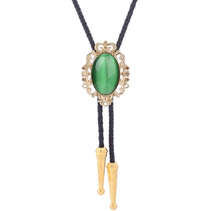 Detail of green turquoise bolo tie with vintage gold crown pattern and black leather cord