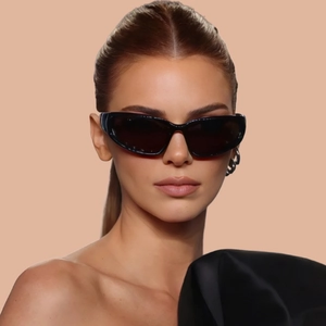 Close-up of Y2K futuristic wrap-around cat eye sunglasses with wide temples on model