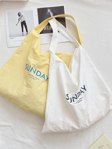 Minimalist canvas tote bags with Sunday Summer Night lettering in yellow and white