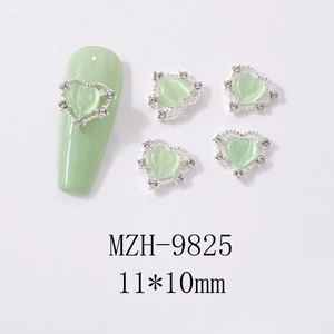 Macro view of heart cat-eye nail art charms with silver rhinestones and 11x10mm size