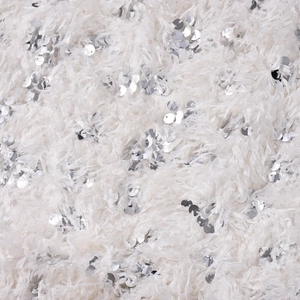 Macro close-up of white plush fabric with silver sequins on a sexy slim-fit mini dress