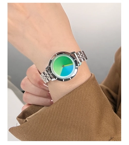 Close-up of minimalist steel watch with a colorful gradient dial on a female wrist