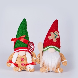 Detail of red and green knitted Christmas gnomes with gingerbread patterns and plush hats