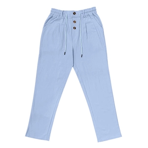 Close-up of baby blue cotton linen pants featuring drawstring waist and button fly detail