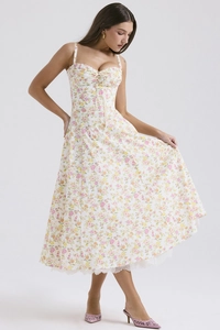 Floral midi dress with lace trim and bow neckline on a minimalist studio background