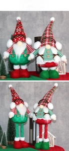 Detail of Christmas gnomes with retractable legs in classic red and green festive colors