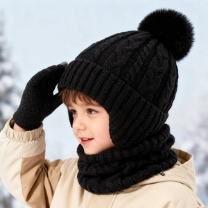 Kids black cable knit winter set including a pompom earflap hat, scarf, and gloves