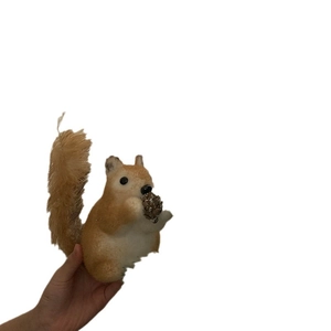 Cute sisal squirrel ornament with pinecone for Christmas tree decoration on white backdrop