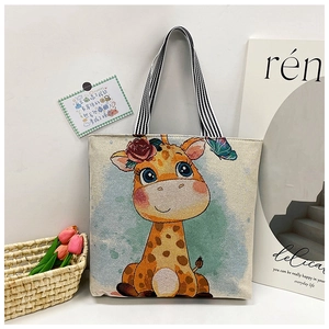 Detailed view of canvas tote bag featuring giraffe print and striped woven handles