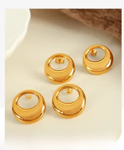 Macro detail of gold-plated hollow hoop earrings with mirror-polished surface finish