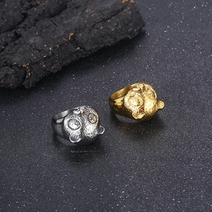 Macro shot of 316L stainless steel panda rings in gold and silver on black background