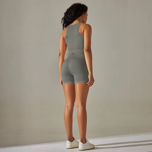 Close-up of seamless gray-green knitted racerback yoga set showing ribbed fabric texture
