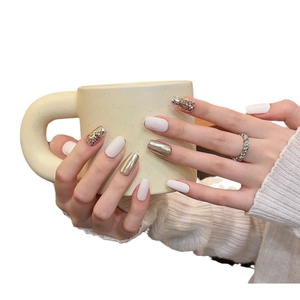 Handmade press-on nails in creamy white, gold mirror finish, and sparkling glitter styles