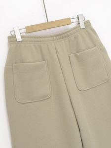 Detail view of khaki joggers featuring elastic waistband and two rear patch pockets