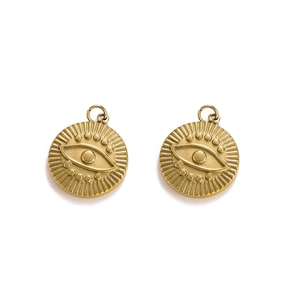Detailed macro view of golden evil eye pendants with radial patterns and top hanging loops