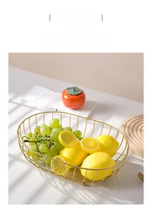 Detail of Nordic golden iron fruit basket with lemons and grapes in a minimalist home setting