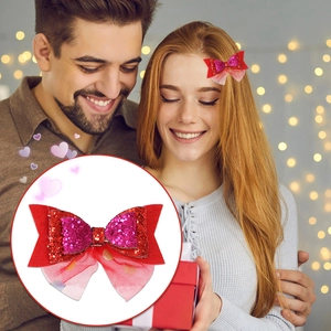Macro detail of red sequin heart bow hair clip with sheer mesh lace decoration