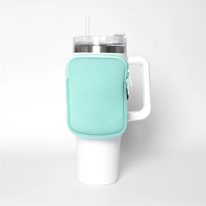 Detail of mint green zipper pouch attached to a 40oz white insulated tumbler cup