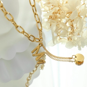 Gold plated stainless steel necklace with letter M pendant and round disc charm