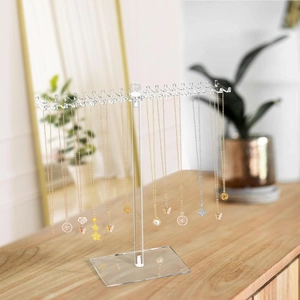 Clear acrylic T-shaped necklace organizer with double-sided hooks on wooden tabletop