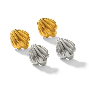 Macro view of shell-shaped stud earrings in polished 18k gold and silver stainless steel