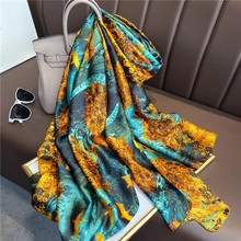 Detailed texture of silk wool scarf with golden thread draped over a leather sofa
