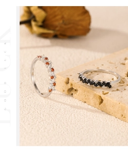 Close-up of S925 silver rings with colorful zircon stones on natural stone background