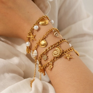 Gold layered shell and starfish bracelet set for beach vacation with pearl charms