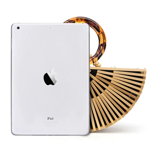 Handmade bamboo handbag with amber acrylic handle next to an iPad for size reference