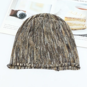 Detailed macro view of the colorful mixed-yarn knit hat with stylish distressed hole patterns