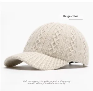 Detail of beige knit baseball cap showing thick diamond texture and ribbed brim