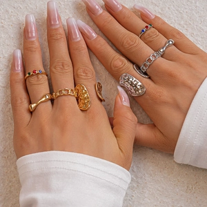5-piece gold and silver stackable geometric rings with rhinestones on hand