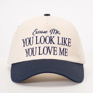 Two-tone baseball cap in beige and navy blue with embroidered quote for outdoor style