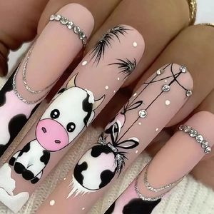 Extra-long matte pink press-on nails with cartoon cow pattern and rhinestone chain