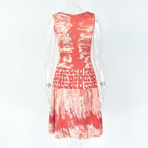 Detail of waist pleats and abstract tie-dye print on orange sleeveless A-line dress